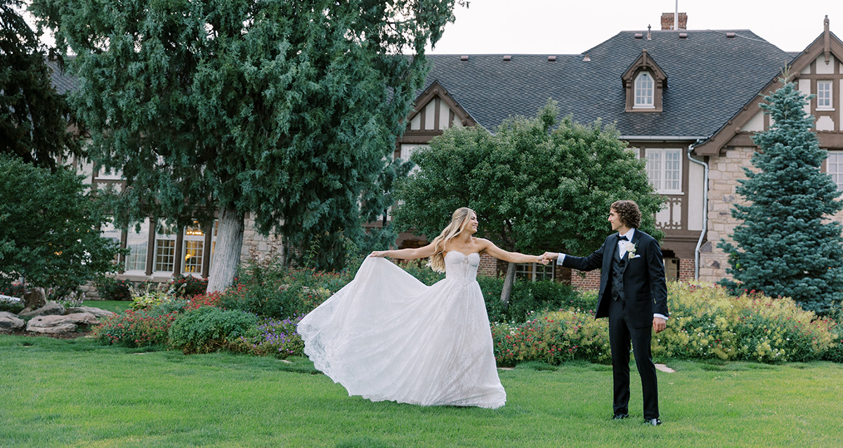 Bride and groom dance hand-in-hand in the backyard of the Mansion grounds.