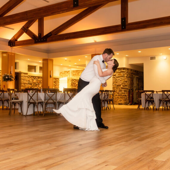 Groom dips bride while dancing in the Great Hall.