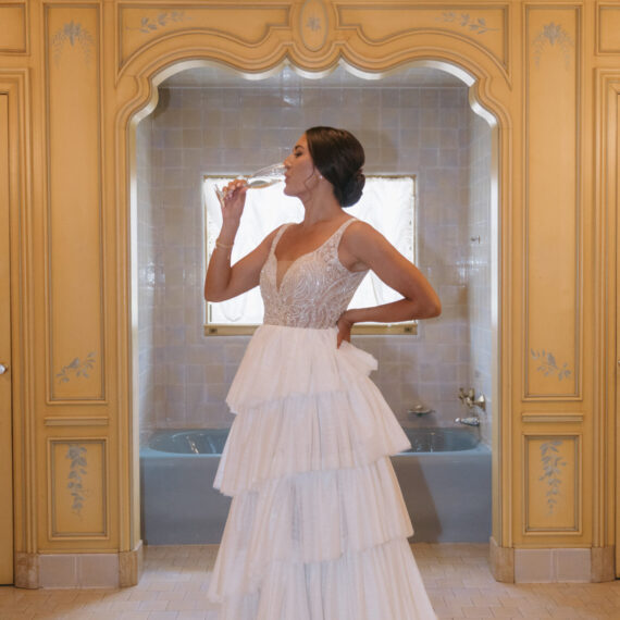 A bride takes a sip of her champagne in the Bridal Suite.