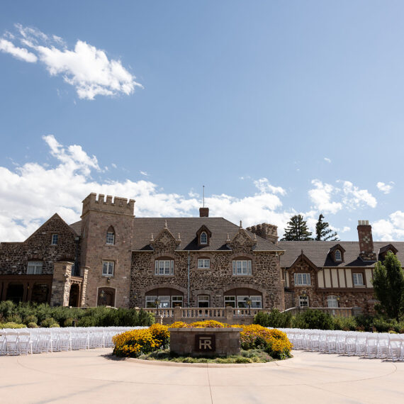 The Mansion front circle drive planter with white folding chairs around it set up for a ceremony.