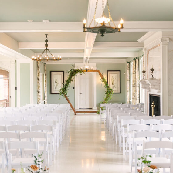 The Solarium set for a ceremony with a wooden arch in the background.