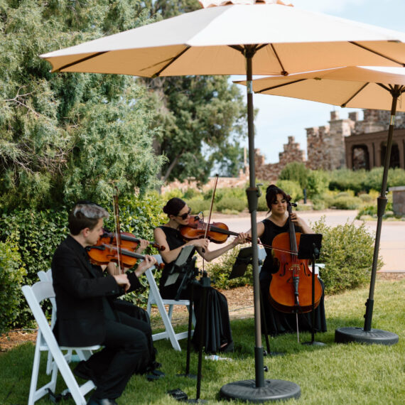 Violinists play on the West Lawn during cocktail hour.